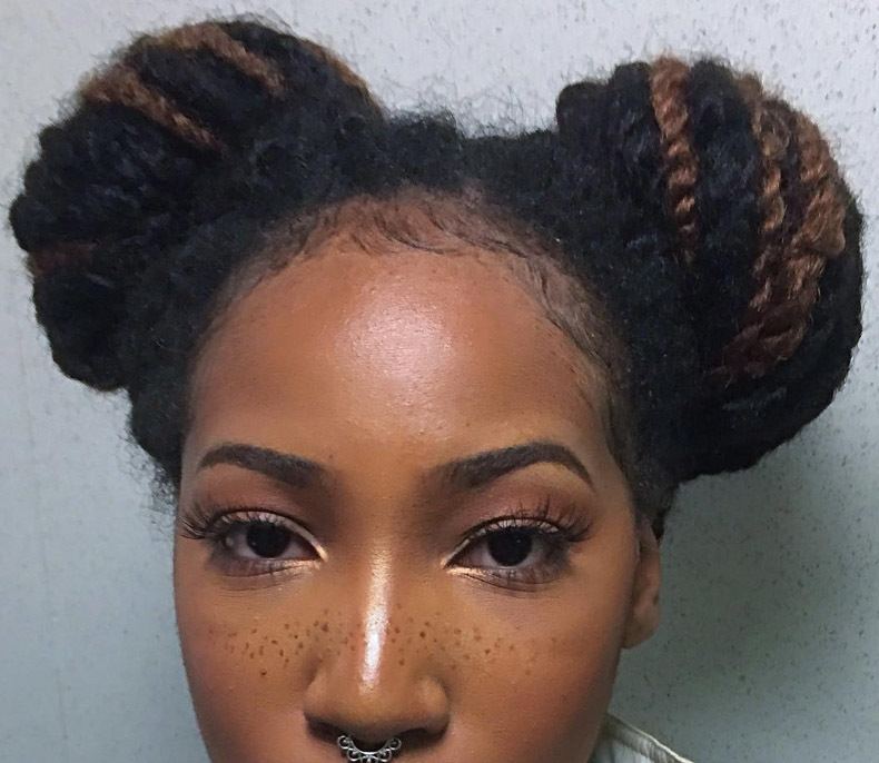 front view of a woman with her hair in marley twists and cute space buns