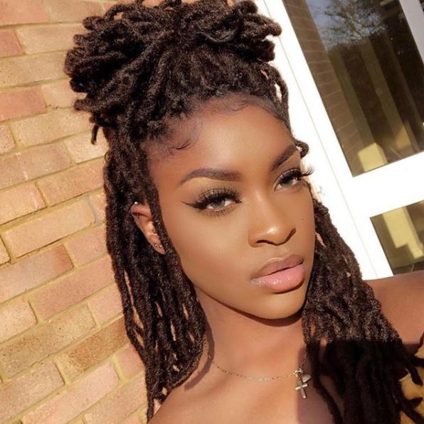 Woman with half-up pineapple on marley twists 