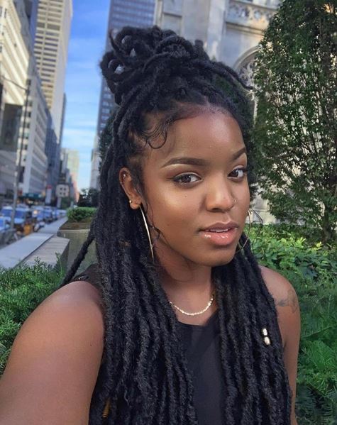 Woman with long marley twists in a half-up, half-down 