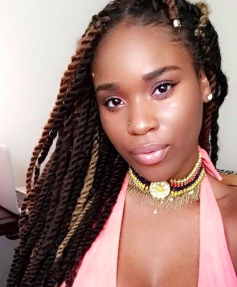 front view of a woman with long marley twists with different colours 