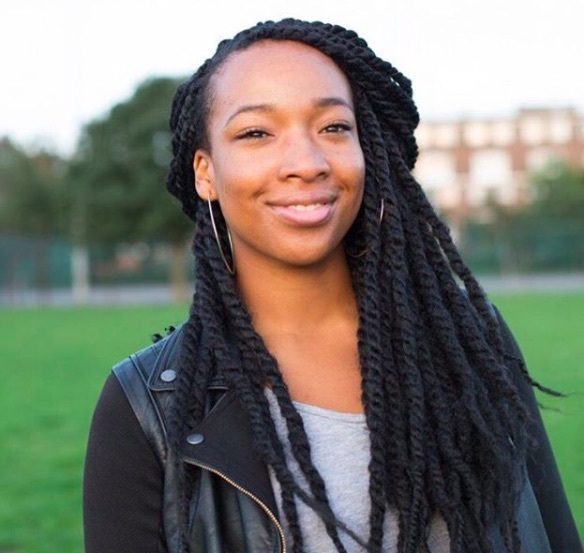 front view of a girl with marley twists in a half up half down style