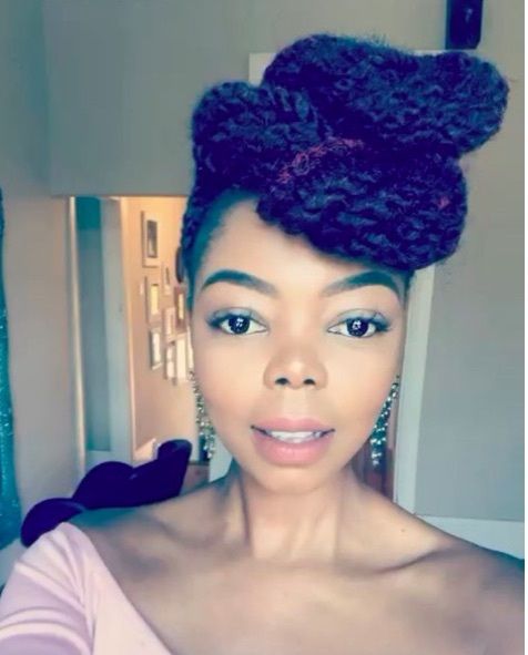 front view of a woman with her hair in marley twists in an up do