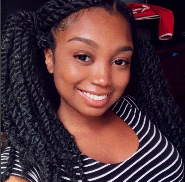 front view of a woman with her hair in pigtails and marley twists 
