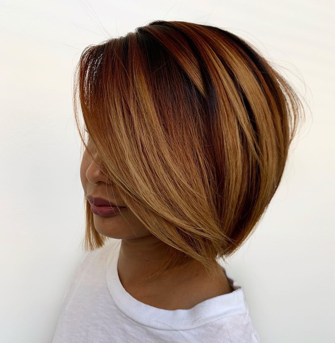 Woman with short layered copper bob