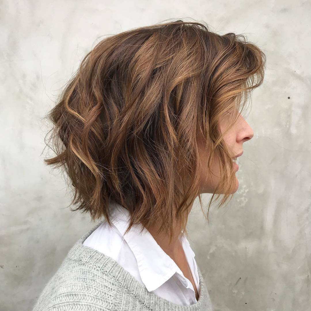 Woman with short layered caramel bob