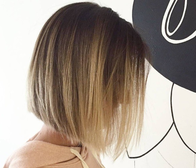 Layered bob: Side profile of a woman with a blonde bob hairstyle with layers
