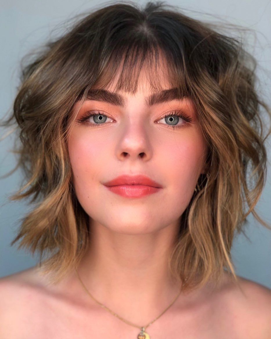 Woman with short shag haircut with fringe