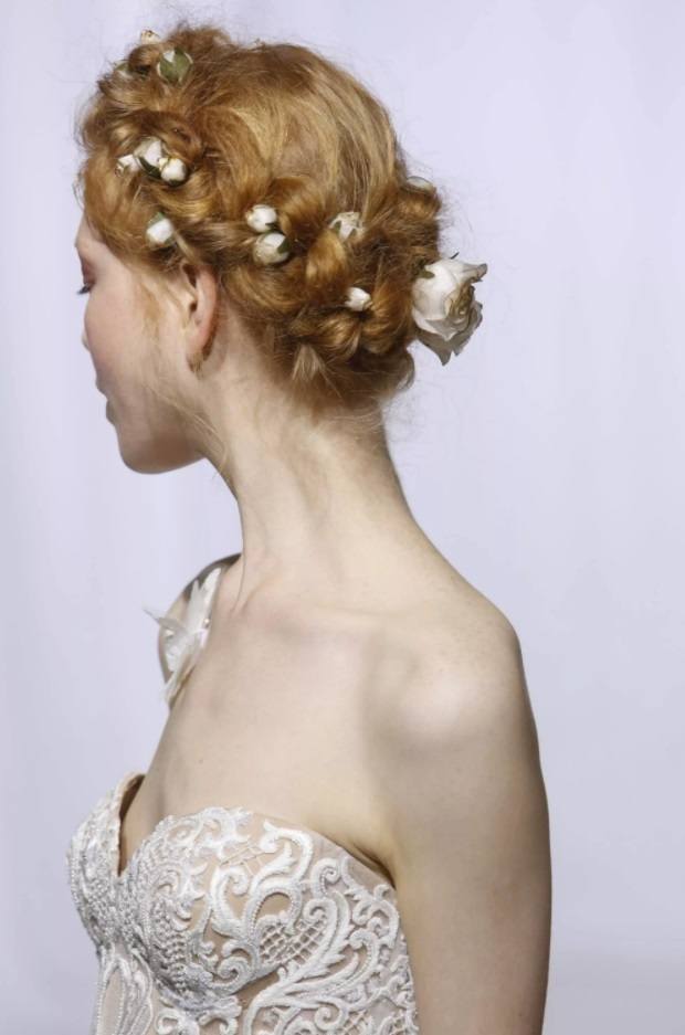 strawberry blonde bridal model with her hair in a delicate floral updo