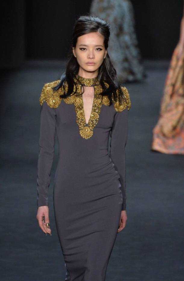 model on the runway with a half up beehive wedding hairstyle
