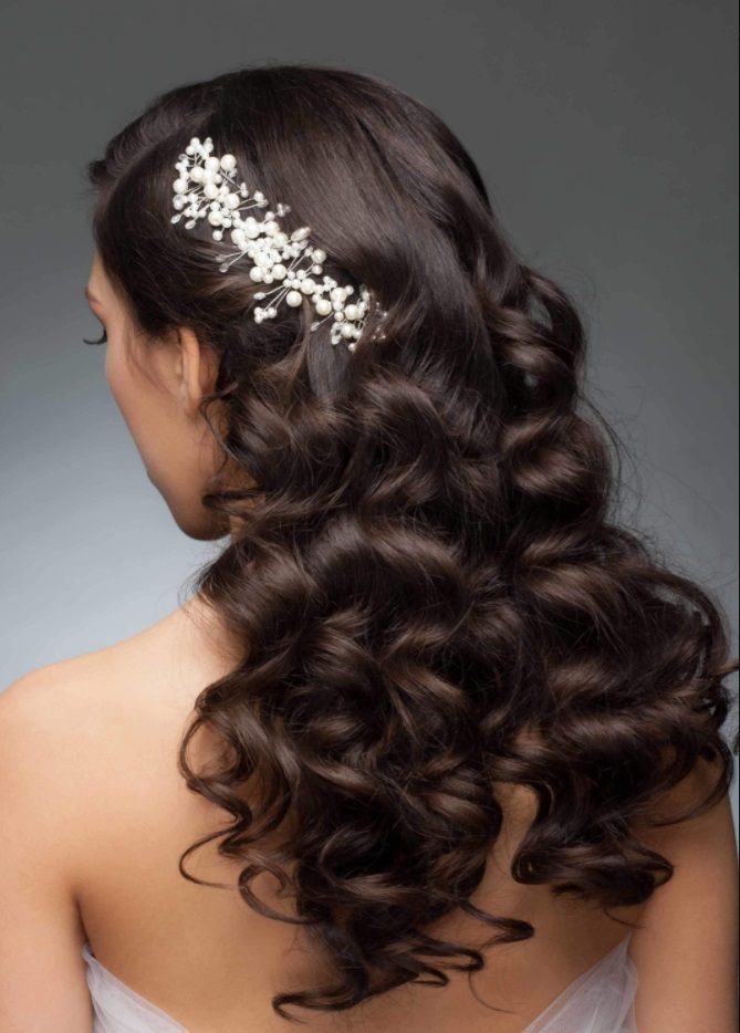 brunette model with wavy long hair with a glitzy hair accessory