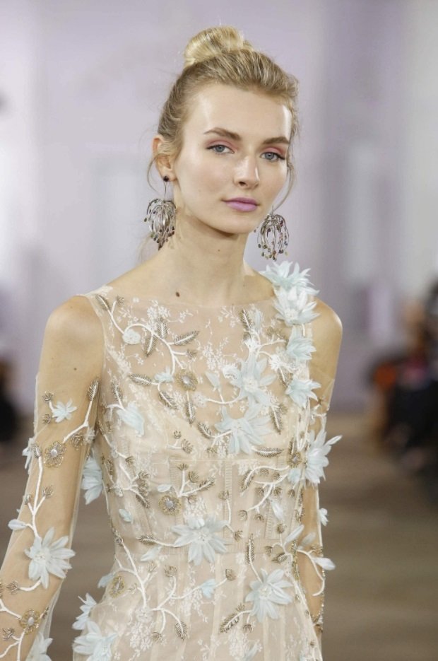 blonde bridal model on the runway with a simple updo hairstyle