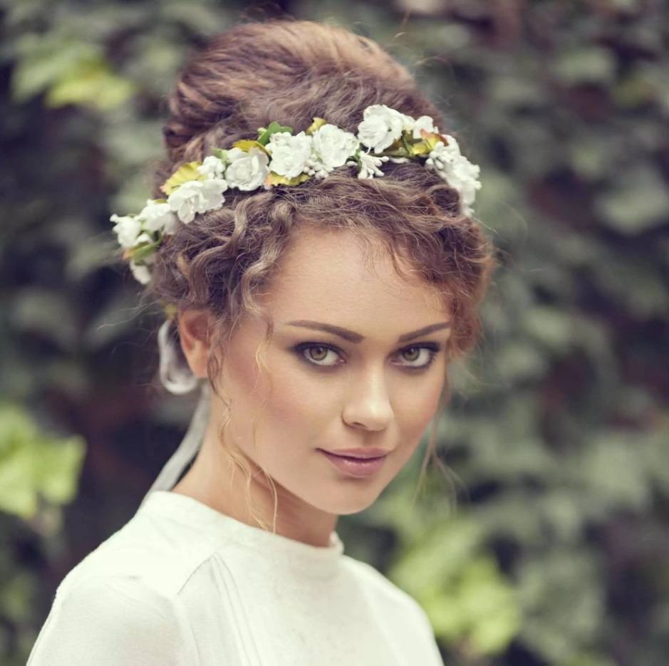 bridal model with brunette curly hair in a bun hairstyle