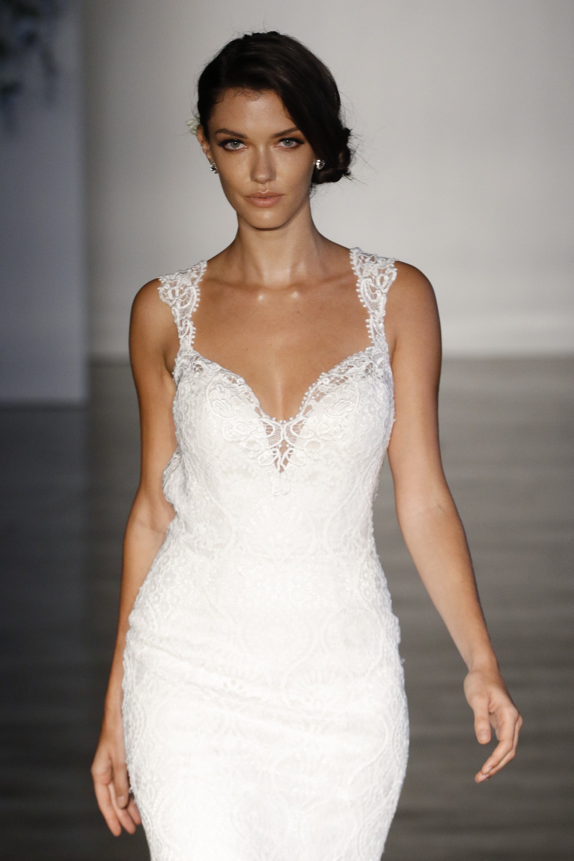 brunette bridal model on the runway with a side chignon hairstyle