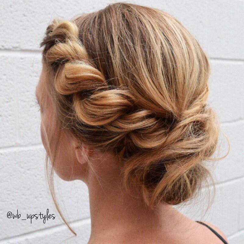 Wedding hair ideas: Woman with honey blonde hair styled into side rope braid twisted chignon