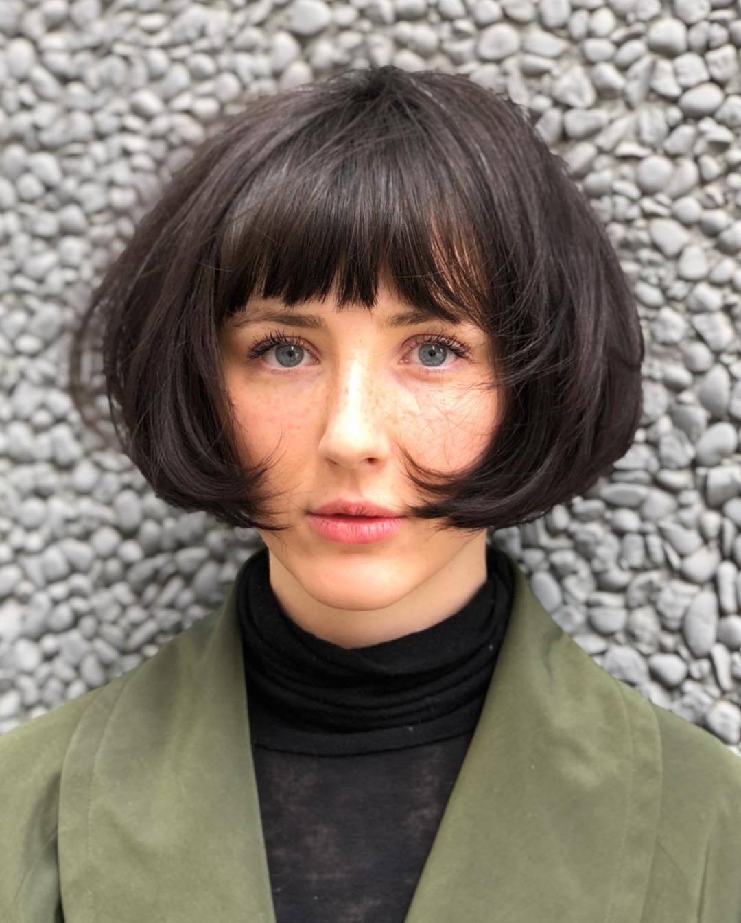 Woman with dark brown short bob with fringe