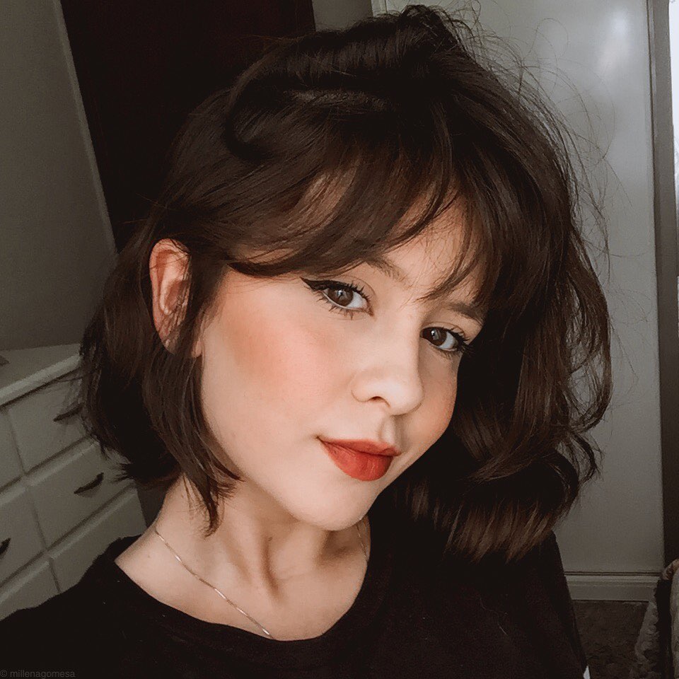 Woman with layered dark brown thick French bob haircut