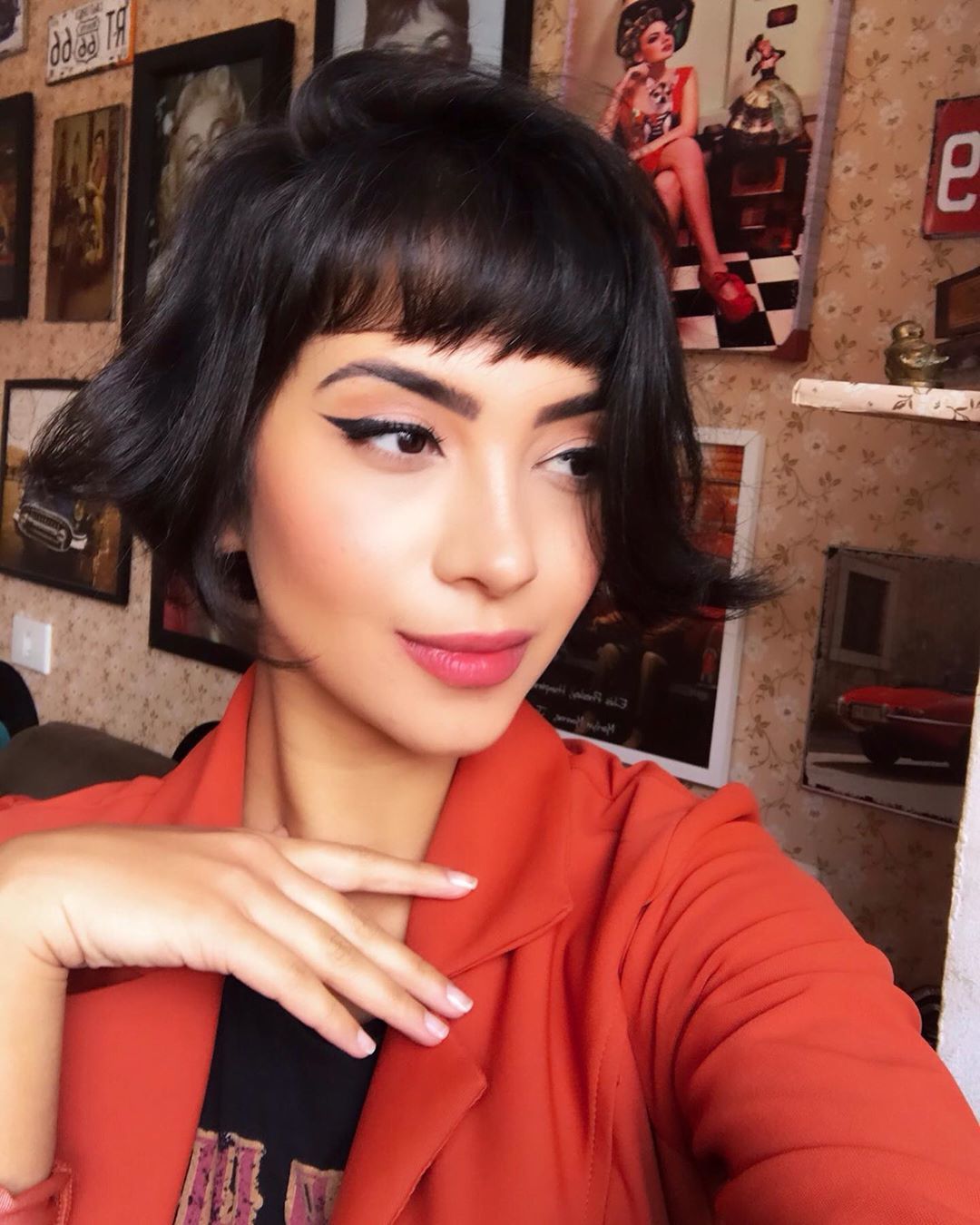 Woman with dark brown short bob with choppy bangs