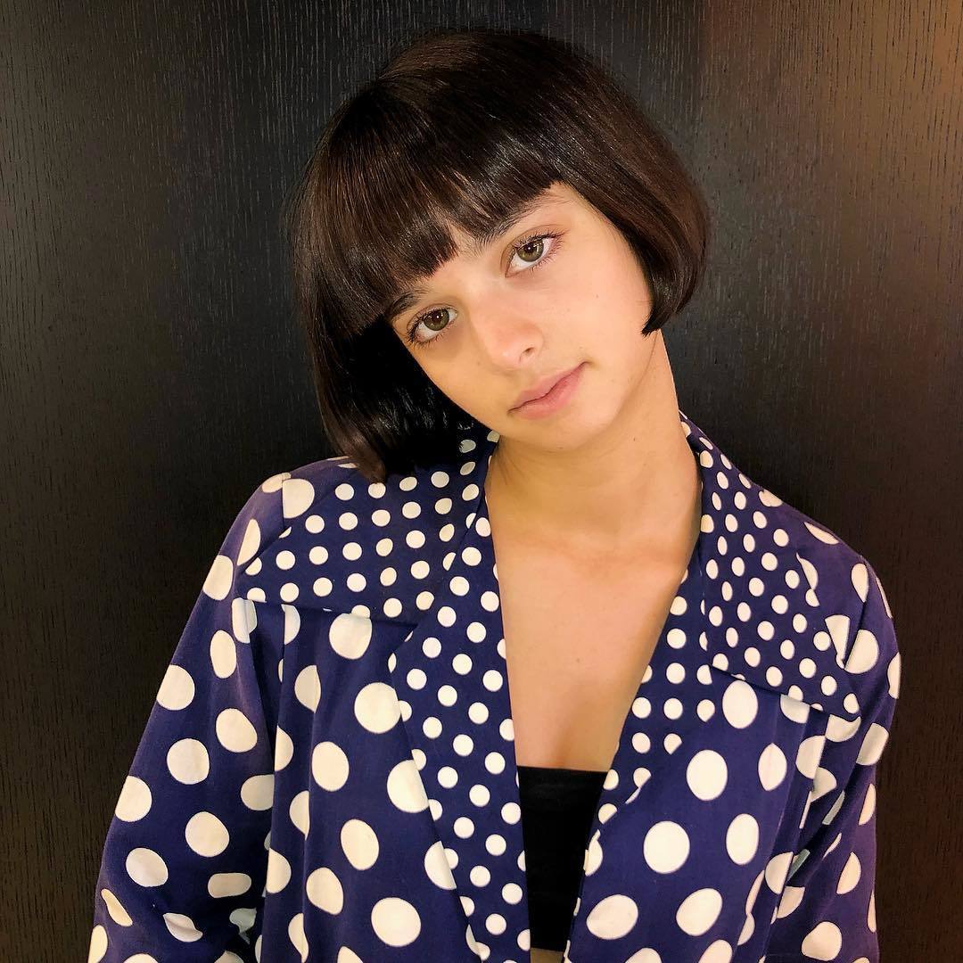 Woman with dark brown blunt cut bob haircut