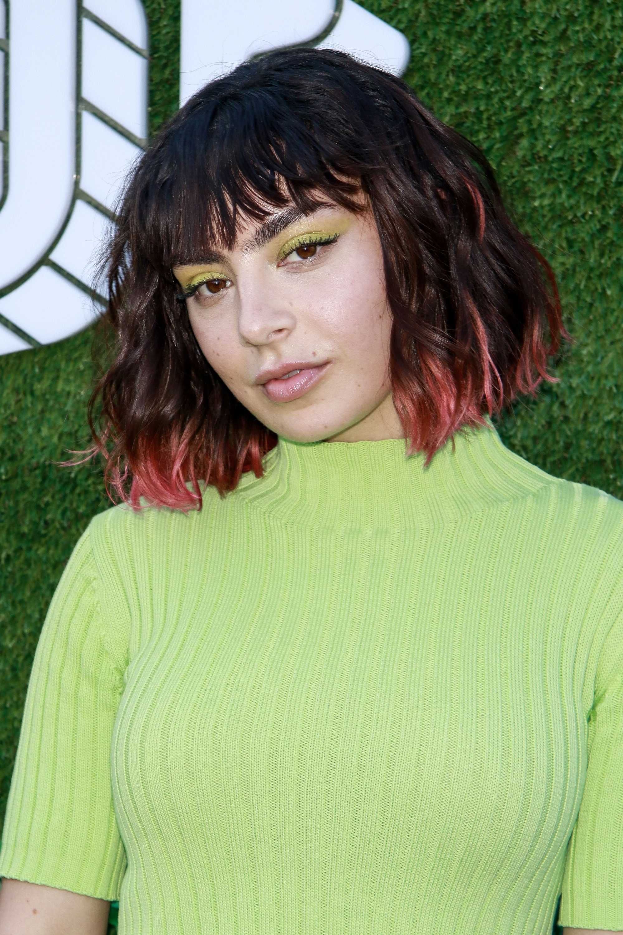 Charli XCX with dark brown bob with pink ombre ends and choppy fringe