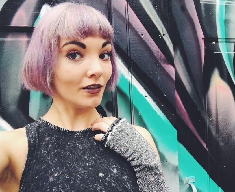Woman wearing grey top with lilac short French bob hair