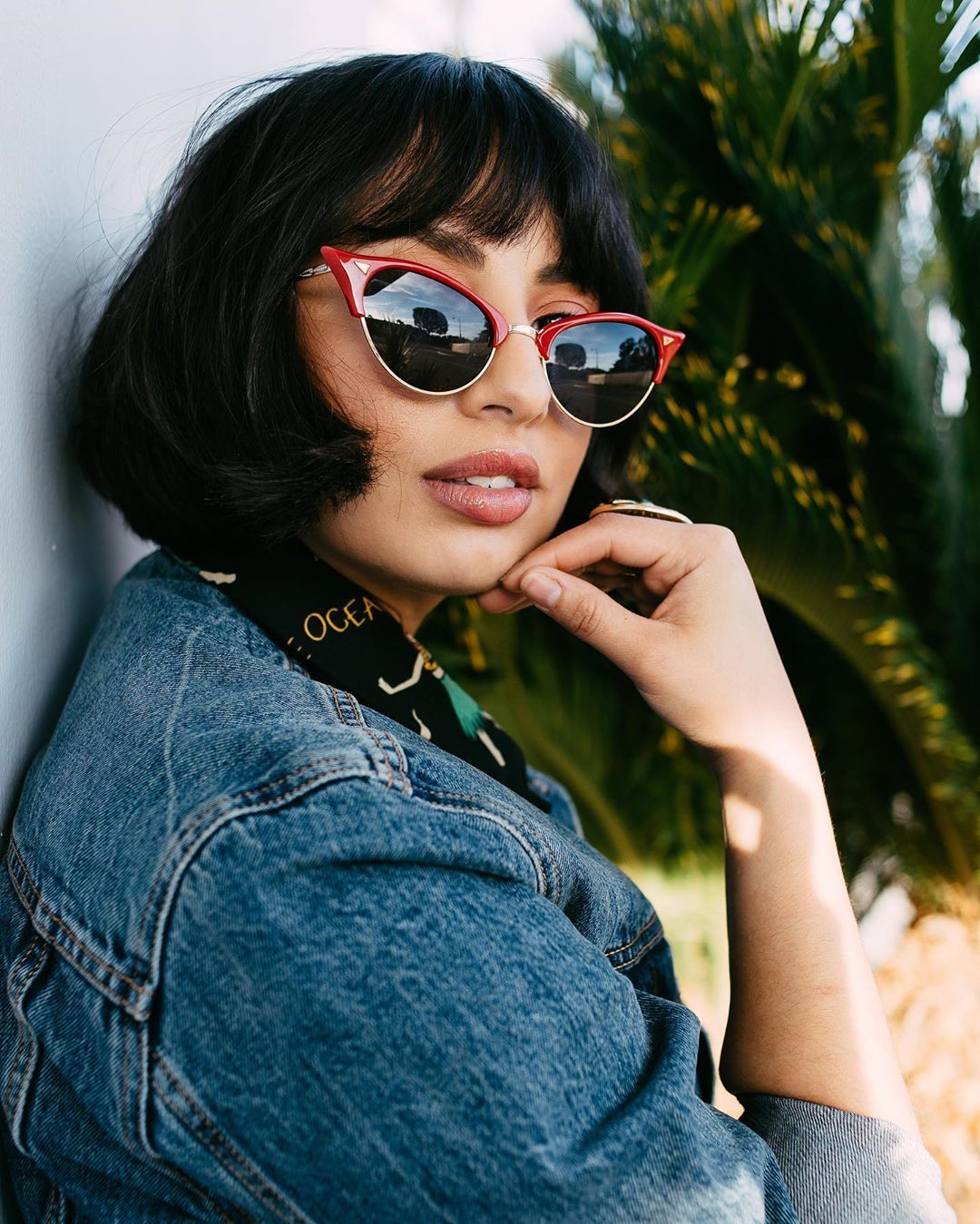 Woman with dark, short French bob haircut with bangs