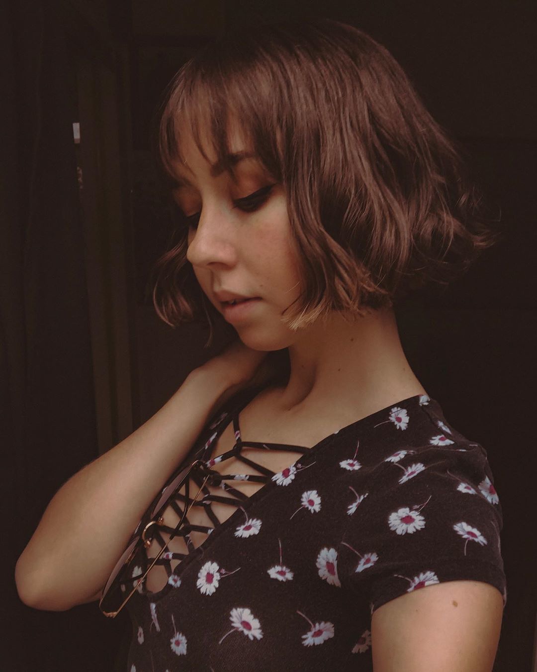 Woman with chocolate brown French bob with waved ends and wispy bangs