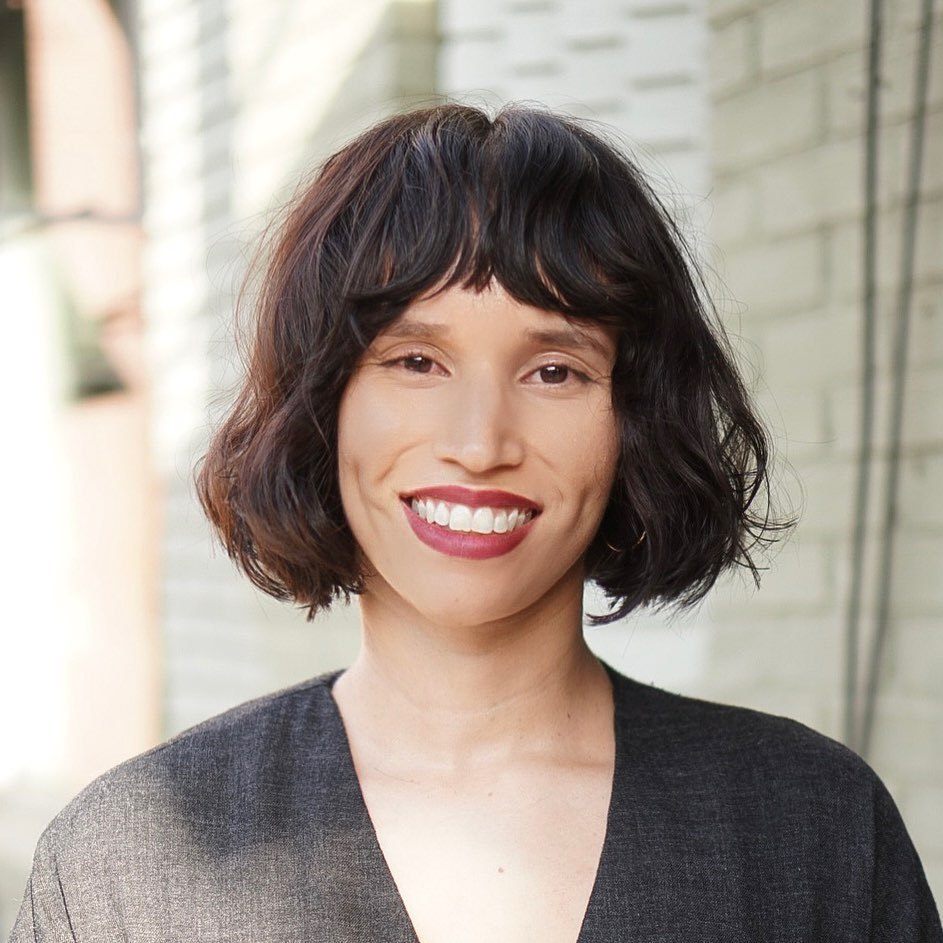 Woman with chin length wavy French bob with bangs
