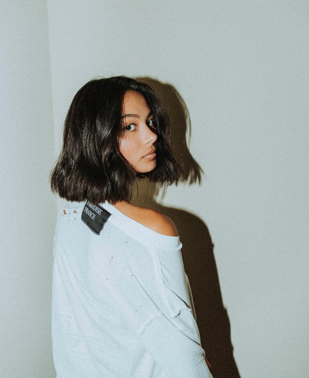 Woman with dark brown, grown out messy bob hairstyle