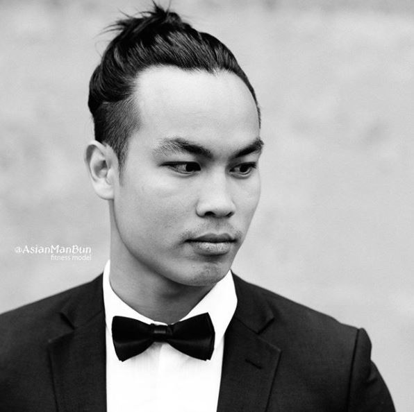 Un homme asiatique, un petit pain : Jeune homme asiatique avec un chignon d'homme bien soigné