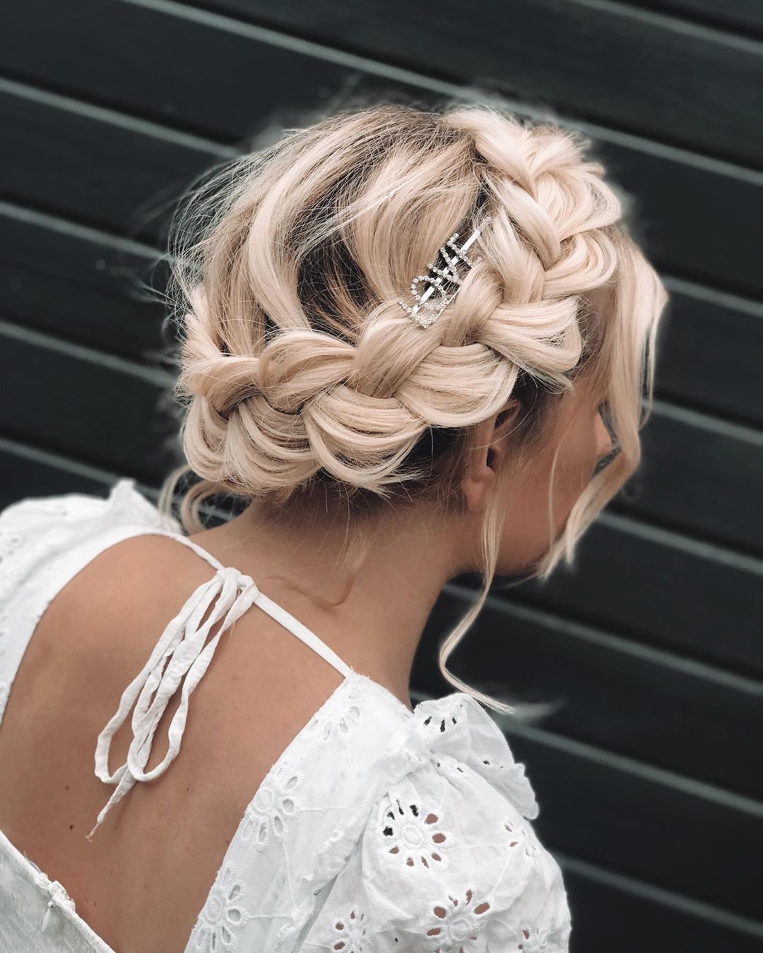 Femme blonde à la couronne tressée, coiffée d'une barrette avec le slogan LOVE
