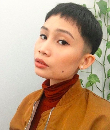 image vue de face d'une femme avec une coupe de cheveux champignon très courte et des cheveux noirs