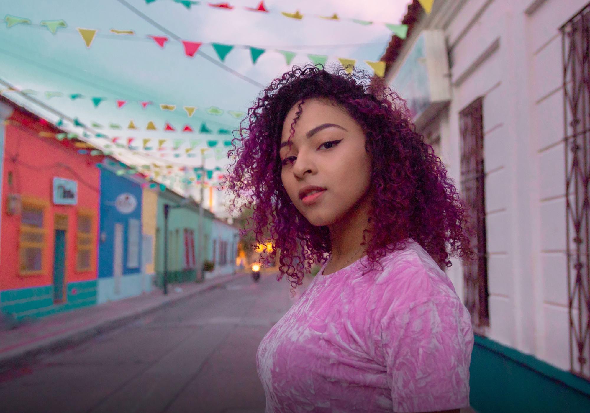 Femme avec des cheveux naturels bouclés violets et ombrés
