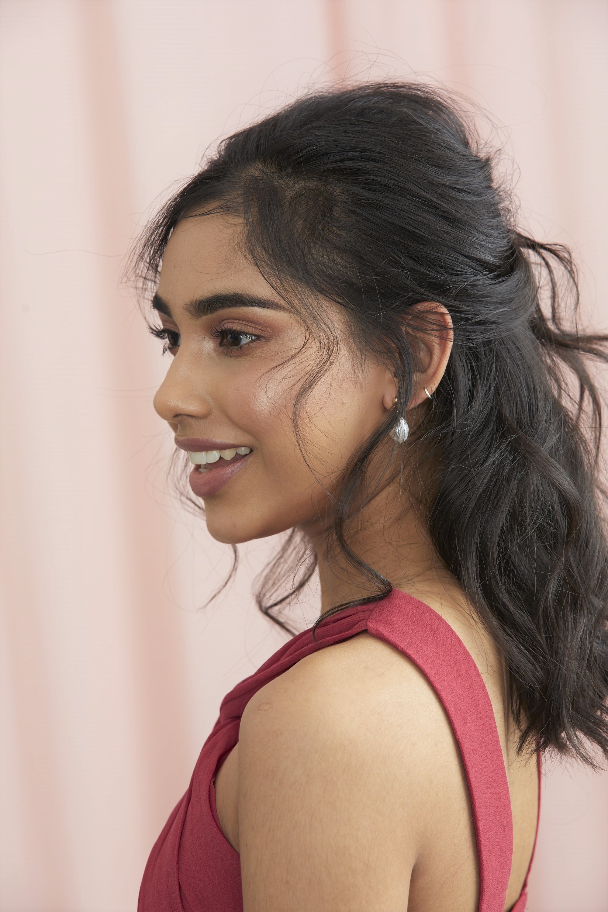 Femme aux cheveux bruns foncés, coiffés en demi-bouffant.