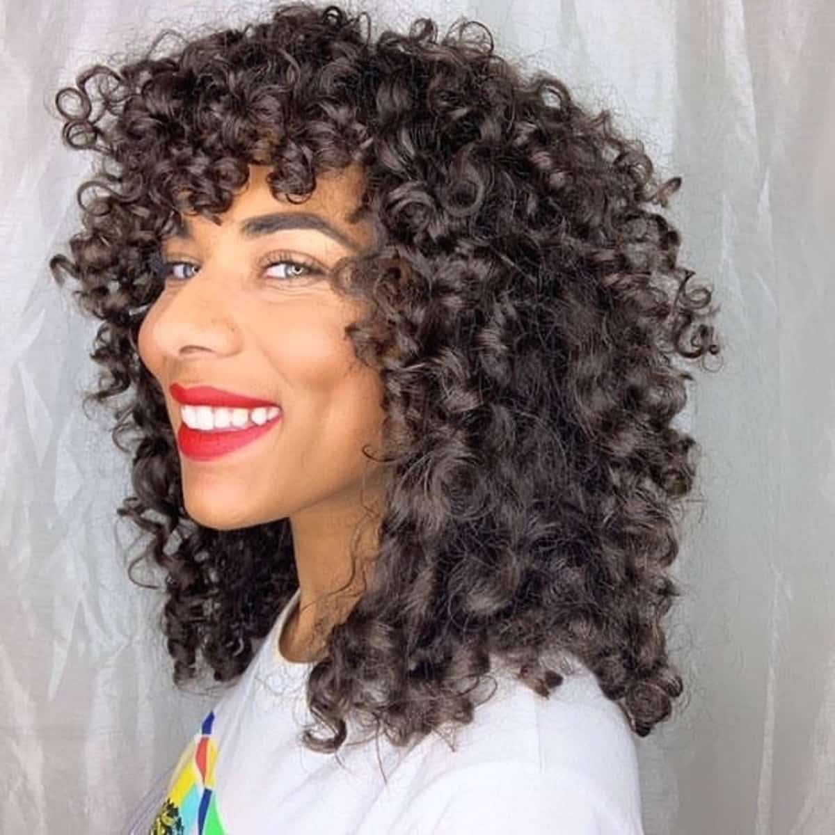 Charmants cheveux bouclés aux épaules