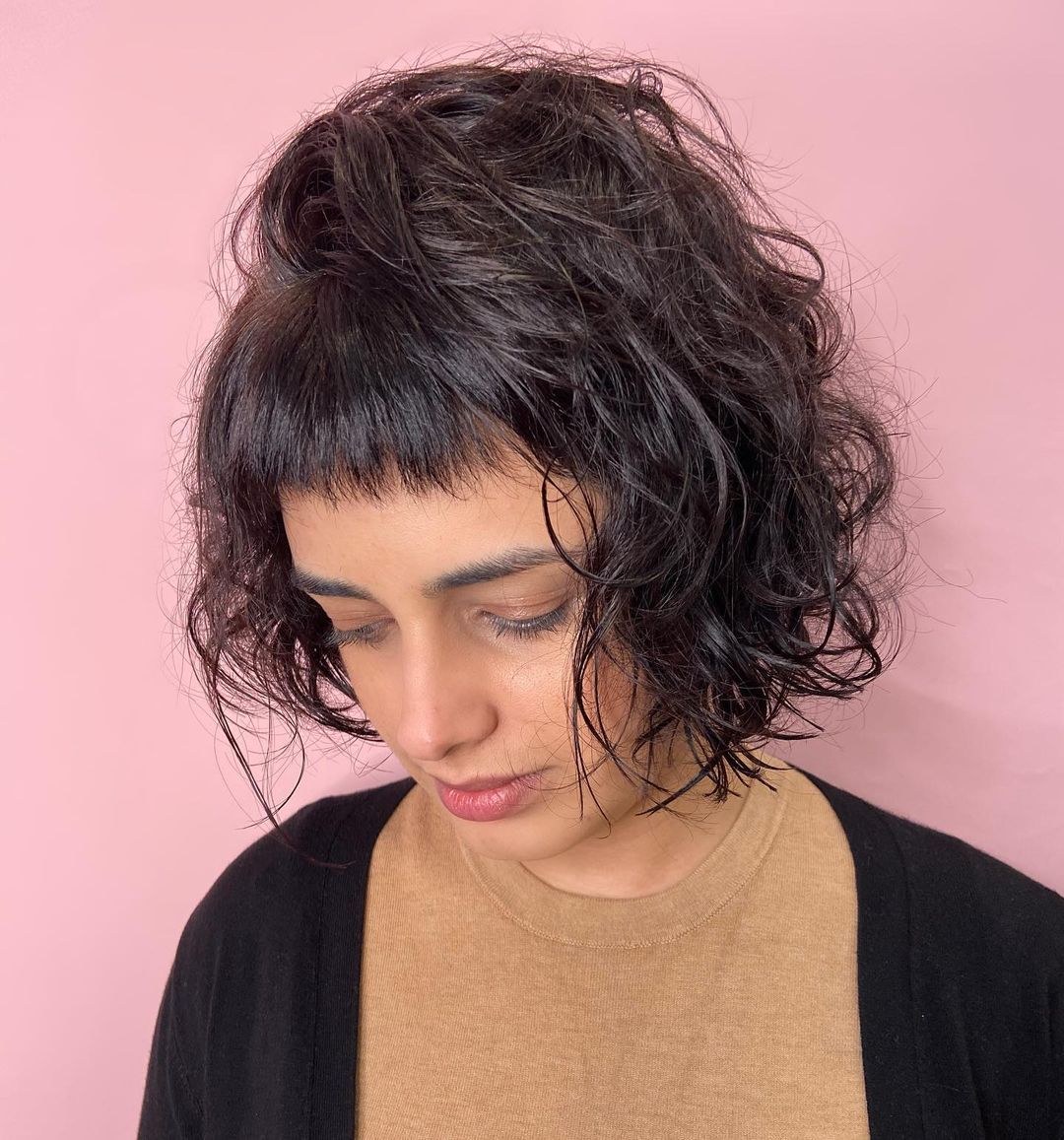 Coupe texturée avec frange coupée et cheveux ondulés