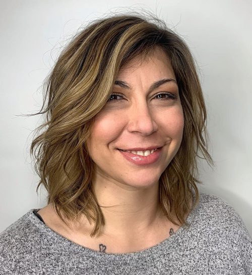 Coiffure courte ondulée avec raie sur le côté