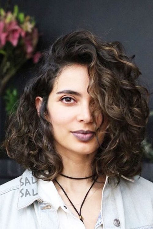 Cheveux bouclés avec une raie sur le côté