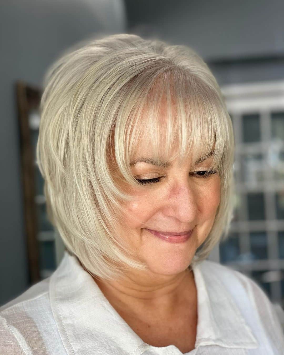 silver shaggy bob with bangs for fine hair ladies over 50