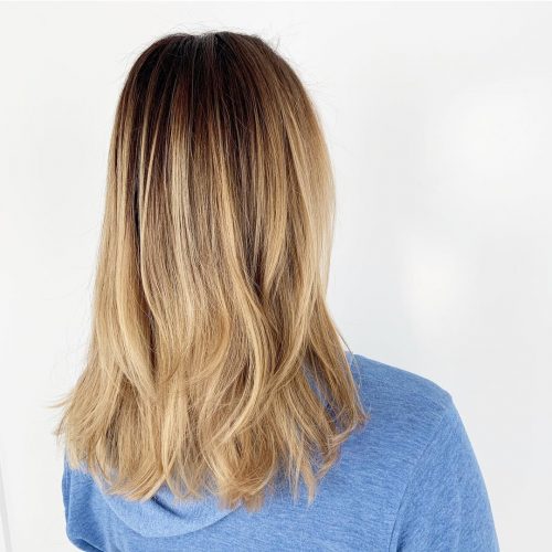 Cheveux blond miel avec des racines brun foncé