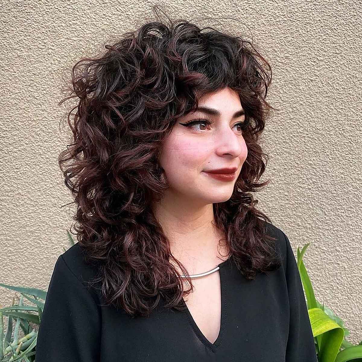 Coiffure rétro, longue, bouclée et hirsute.