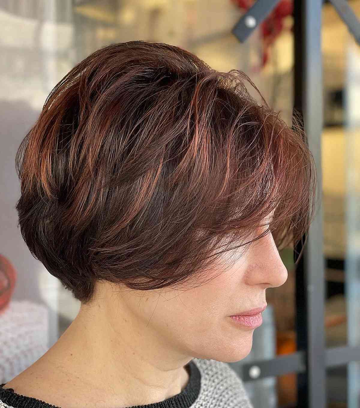 Coupe dégradée très courte avec des reflets auburn et cannelle.