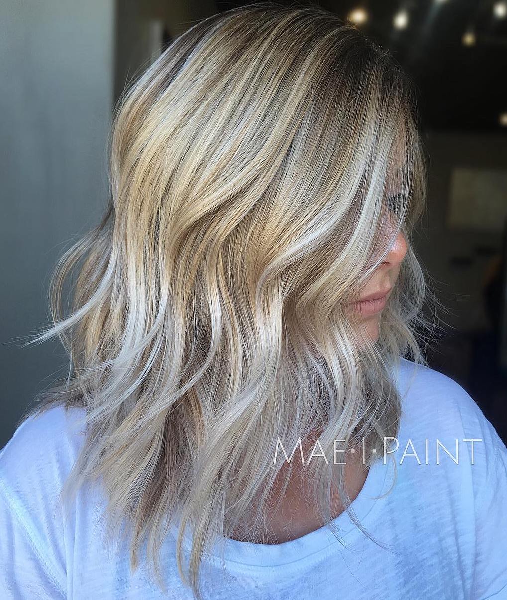Disconnected Shaggy Blonde Long Bob Haircut with Silver Highlights