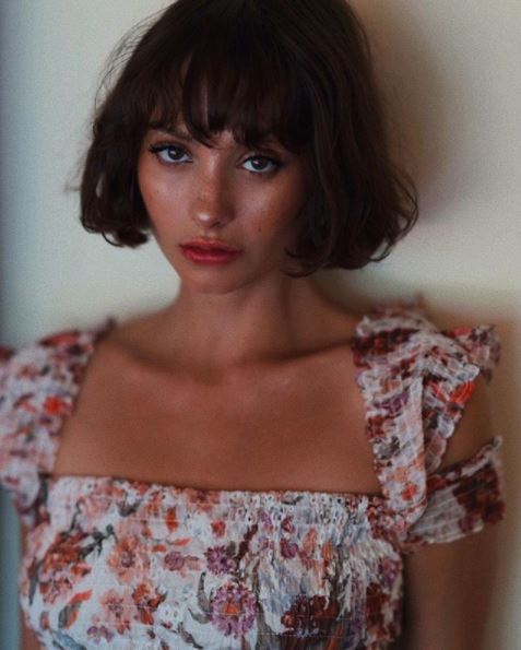 woman with short dark brown bob with bangs 
